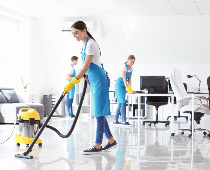 a team of professional cleaners cleaning an office