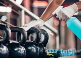 weights and kettlebells being sanitized by professional gym cleaning service in Kitchener-Waterloo