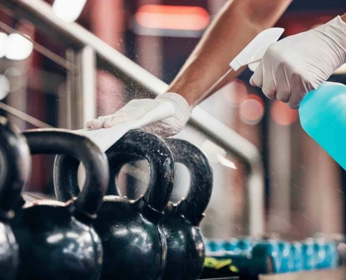 weights and kettlebells being sanitized by professional gym cleaning service in Kitchener-Waterloo