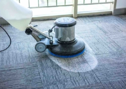 commercial carpet cleaning machine being used by professional commercial cleaner