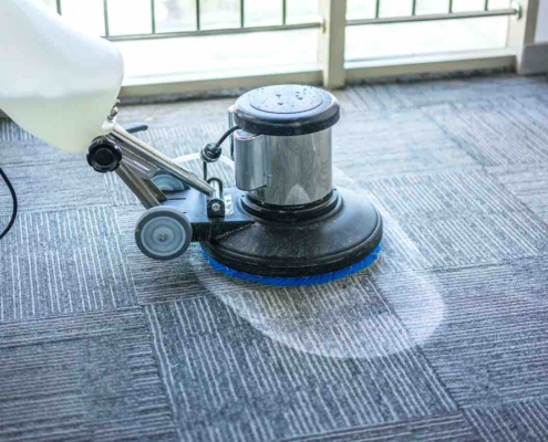 commercial carpet cleaning machine being used by professional commercial cleaner